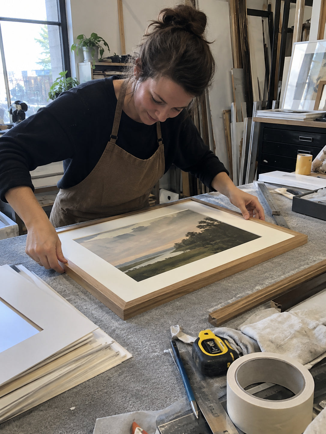 Hand framing an art print in the BiuPicture studio